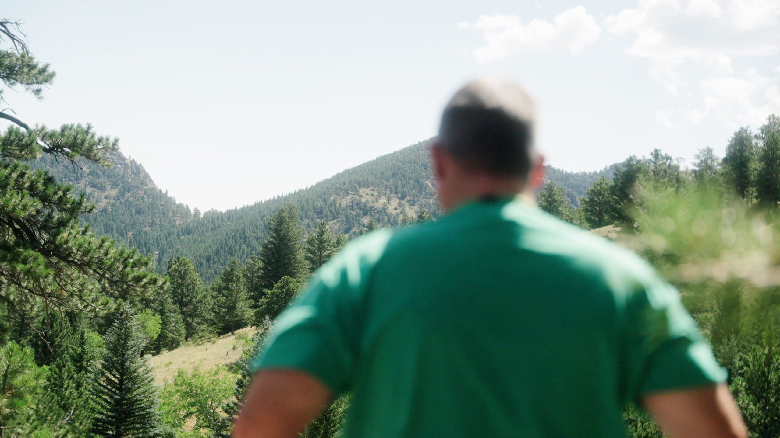 Hiker looking at Harmony's Magic Mountain.